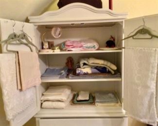 Armoire with bedding, linens, etc