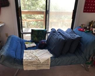 Futon, daybed, adjustable foot and head board.  With denim cover on mattress, nice sheets, etc