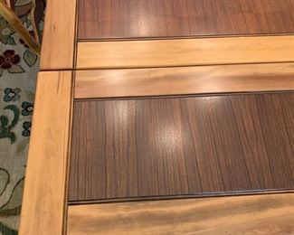 Leaf extended on end of table