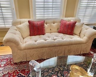 $550 - Tufted roll arm cream box pleat skirted sofa.  29"H x 86.5"W x 34"D (seat height 18"H) - Paisley pillows sold separately