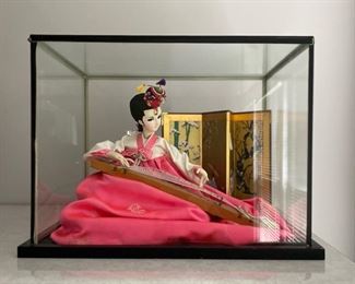 $45 - Korean doll in display case. 12 1/2" H x 17 1/4" W x 13" D