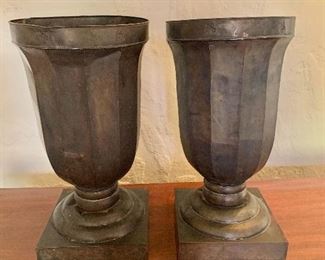 $90  - Pair lightweight metal architectural urns/planters.  One urn detached from base. 18"H x 9"D (base 8.25" x 8.25") 