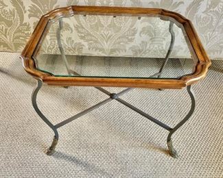 $395 - Regency style wrought iron and glass top side table with wooden frame and hoof feet. 22"H x 28"D x 22"W