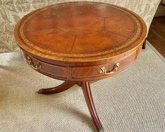 $495 - Regency style drum table with two drawers and leather top.  Pedestal legs finished with brass feet.  Wear consistent with age and use. 28"H x 32"D