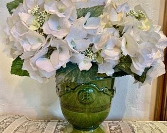 $60 - Glazed ceramic green vase with artificial flowers.  16"H x 16"W (vase 9"H x 7.25"D)