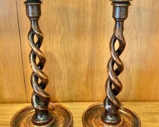 $60 - Pair of twisted wood candlesticks with metal top. 12"H x 5.5"D