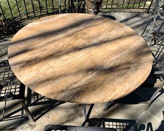 $900; Wrought iron table with limestone top; table 1