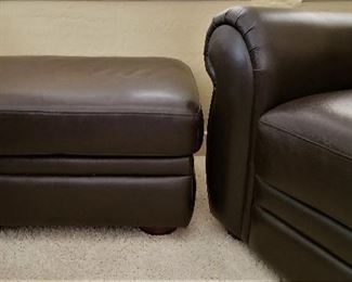 Black matching ottoman to the chair and sofa.