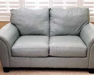 Pale blue gray leather loveseat