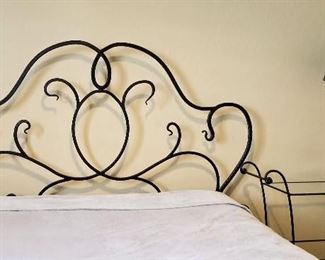 Black wrought iron bed. Queen mattress also for sale. Matching side table and lamp for sale too.