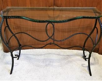 Black wrought iron and glass console table. Use in the entryway or hallway or at the end of the wrought iron bed we have for sale.