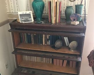3 section lawyers or doctors bookcase, filled with some wonderful books. Gwen Fostic 11 pc set on top along with some pottery!