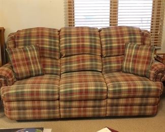 Handsome plaid couch features two side recliners.