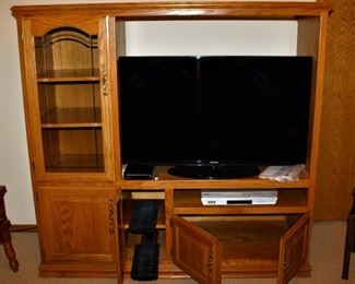 Solid wood entertainment center is in excellent condition with plenty of storage.