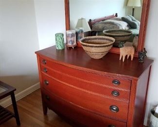 Vintage mahogany dresser in guest room, with coordinating mahogany bed.