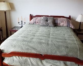 Full size mahogany bed comes with linens and pillows.