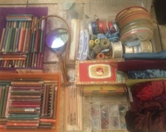 Tubes of seed beads, neck magnifier, cigar boxes, ribbons, velvet fabrics, etc.