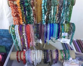 Beads of all persuasions on a rope or strand, the real deal stones and crystals, many more than showing