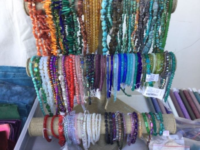 Beads of all persuasions on a rope or strand, the real deal stones and crystals, many more than showing