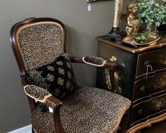 One of two leopard print upholstered chairs