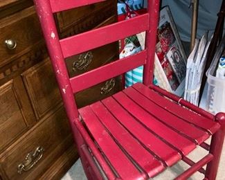 One of several red ladder back chairs