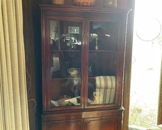 . . . this is a nice 1940's corner cabinet with a display of Longaberger baskets and other treasures