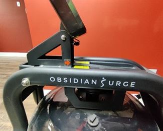 Brand - Obsidian Surge 500 Water Rowing Machine
WATER PERFORMANCE
Row on the water in the comfort of your home. The water creates a smooth and steady rowing experience with every stroke. Instant resistance is available with the flywheel and 16 fan blades. The faster the fan blades spin the higher resistance and dynamic response caused by the harmonious interaction with the water, giving the user a unique experience.

FITNESS TECHNOLOGY
The Fitness Meter is designed to accurately track all essential workout metrics i.e. Total Time, Time/500M, SPM, Total Strokes, Calories, HR, Ambient Temperature, and more. The Fitness Meter allows the user to tailor a personalized workout or use the built preprogrammed features. Compatible with ANT+ heart rate technology, like heart rate belts or watches, so you can measure an accurate pulse and monitor the effectiveness of your workout. When worn around your chest during your exercise routine, the pulse belt will transmit your heart rate to the advance