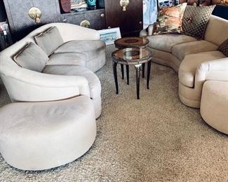 Gorgeous living room with matching sofas, entertainment center, art, and music box tables