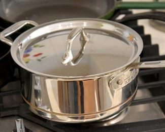 502. LOTS of kitchen wares, including name brands like All Clad, Calphaulon, Crate & Barrell, Emeril, etc. Pots, pans, dishes, stemware, glasses, etc.