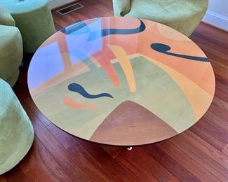 $550 - Round colorful coffee table; 17" H x 39" W, small ding in the top finish