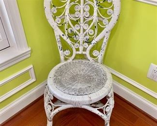 $50 - Distressed, vintage white wicker chair; 38" H x 16" W x 16.5" D, seat height is approximately 17.5" 