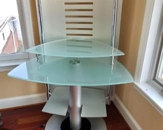 $375 - Contemporary computer stand (tempered glass and brushed metal). 55 in. H overall x 34 in. W x 25 in. depth. Table/first tier of stand H is approx. 29 in.