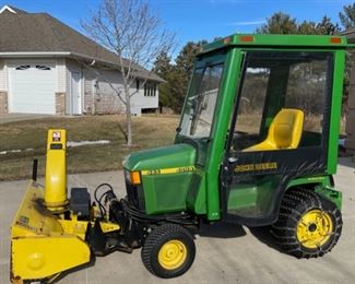 1999 445 John Deere Tractor includes Cab, 46” Snow Thrower, 54” Dirt Blade, 54” Mowing Deck, Lift Mechanism, 6 Weights and Chains. Pamphlets on all included(S018)