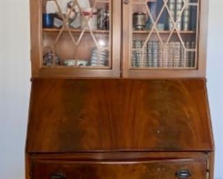 Lot 6002 $395.00 Antique Secretary with Glass Doors and it opens to a desk with cubbies. Very Sweet - if there is a manufacturer's name, perhaps it's on the back. 78" H x 32" W x 16" D