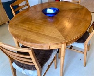 Lot 6003 $400.00. MCM Heritage Oval Dining Table with 6 Chairs (4 side and 2 armchairs). Includes: 2 Leaves each 18"w. Beautiful wood, appears to be Cherry or Pecan? Awesome inlay looking design. 6 Chairs, 58"x45" without leaves in. Chairs need new coverings,
