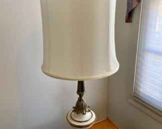 Lot 6051. $65.00. Mid-Century White and Brass Table Lamp. 38"tall. The shade is rough and needs to be replaced or used without. We have 2 of these lamps, the other is in Lot 6153.