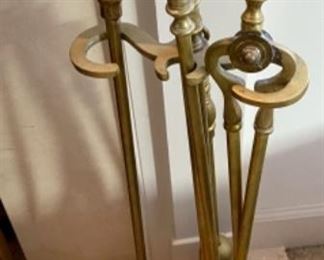 Lot 6054. $50.00 Brass 5 pc, tool set. 26" tall, 9" w, half moon shape. Also Brass Fireplace Log Holder 25.5" long x 15" wide
