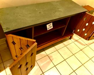 Lot 6082. $265.00 Media console Mid Century Bi-Fold doors with Keyhole Cut Outs. The top is a solid piece of slate that needs a good cleaning and sealing. 45"w x 15.5 deep x 25" high. This is a terrific credenza/console, with folding doors and a thousand uses, eclectic but with a definite Mid Century appeal.