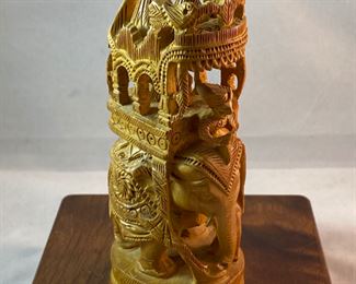 Lot 6100. $40.00. Intricate Wood Carved Elephant carrying riders in a two-tiered animal taxi. Probably meant for the tourist trade but it's very NICE. The two pointy turrets or whatever they are called on the top do remove for easier packing, and the whole unit is very interesting! 5"t x 2"w