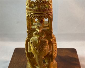 Lot 6100. $40.00. Intricate Wood Carved Elephant carrying riders in a two-tiered animal taxi. Probably meant for the tourist trade but it's very NICE. The two pointy turrets or whatever they are called on the top do remove for easier packing, and the whole unit is very interesting! 5"t x 2"w