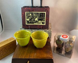 Lot 6101. $48.00 8 pretty trinkets with an Asian theme: 2 cloissoné mini vases on stands (2"tx1.5"w), 2 stone goblets with silk box (2" x 1.5"dia), hinged cut box about 3"x2", (I believe this is a cricket box - catch a cricket, put in box and you will have good luck) 2 jadeite cups with gift box, sailboat pendant/pin with small box (1.5"t x 1"w)