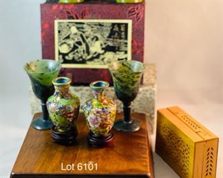 Lot 6101. $48.00 8 pretty trinkets with an Asian theme: 2 cloissoné mini vases on stands (2"tx1.5"w), 2 stone goblets with silk box (2" x 1.5"dia), hinged cut box about 3"x2", (I believe this is a cricket box - catch a cricket, put in box and you will have good luck) 2 jadeite cups with gift box, sailboat pendant/pin with small box (1.5"t x 1"w)