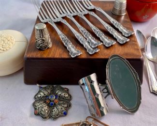 Lot 6105.$60.00. 6 sterling cocktail forks, 5 sterling demitasse-spoons, lipstick case w/mirror, filigree silver pendant w/lapis & coral stones, 2 thimbles, covered decorated lacquered and a "faux" ivory string box.