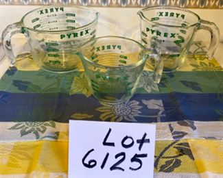 Lot 6125. $60.00 . One Pyrex 10" glass pie plate, 2 Chefmate non-stick cake pans, 3 Pyrex measuring pitchers with green writing, vintage measuring spoons. Note: To Pyrex fans, these measuring cups with the green writing are scarce - they sell for $42 each online.