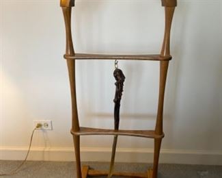 Lot 6141. $75.00 Fitwell Valet by C.Birnbaum Ltd. w/driftwood handled shoe horn that connects on a brass hook. Needs one more screw and wing to even it out.