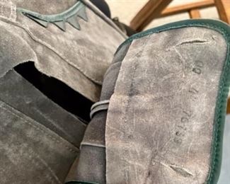 Lot 6146. 60.00 Child Size leather boots with some kind of weight on the inside, these could be used as a book end or decor. Also a Spain-Made Beret with an Eagle Emblem and a pair of Leather Child size Leiderhosen.