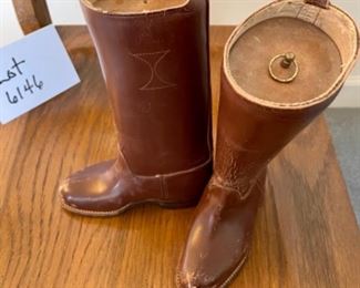 Lot 6146. $60.00 Child Size leather boots with some kind of weight form on the inside, these could be used as a book end or decor. Also a Spain-Made Beret with an Eagle Emblem and a pair of Leather Child size Leiderhosen.