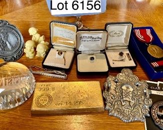 Lot 6156. $75.00. Lot of Random but cool items: 1.Univ. of Miami Heritage Society Paperweight, 2, The Great Seal of State of Montana Pewter Gelt Buckle c.1986, 3, Three little resin figurines, 4. 3 tie pins - one tiger eye, one genuine mother of pearl and one onyx or similar, 5, Tie clip by Hickock, 6.One Replica of Gold Bar (heavy), 7. Good Conduct Medal from WW2, c. 1944 in Box, 8. Pewter Belt Buckle Crest, 9. Clan Crest Murray Clan - Scotland, 10. Photo of W.C. Fields