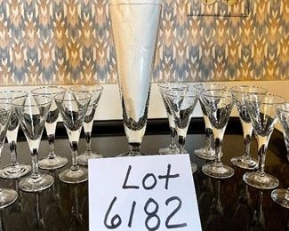 Lot 6182. $28.00 Thirteen Vintage Crystal Glasses. (4.25"t) and one larger pilsner glass in a coordinating pattern (8.5"t) with a starburst design. Vintage Glasses. 13 cordial glasses (4.25"t) and one larger pilsner glass in a coordinating pattern (8.5"t) with a starburst design.