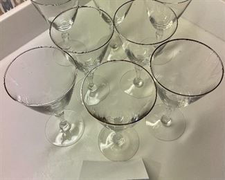 Lot 6192A. $32.00. Lot of 8 Fostoria Water Goblets or Wine Stems 7"tall with Fostoria marking on base. Silver rim.